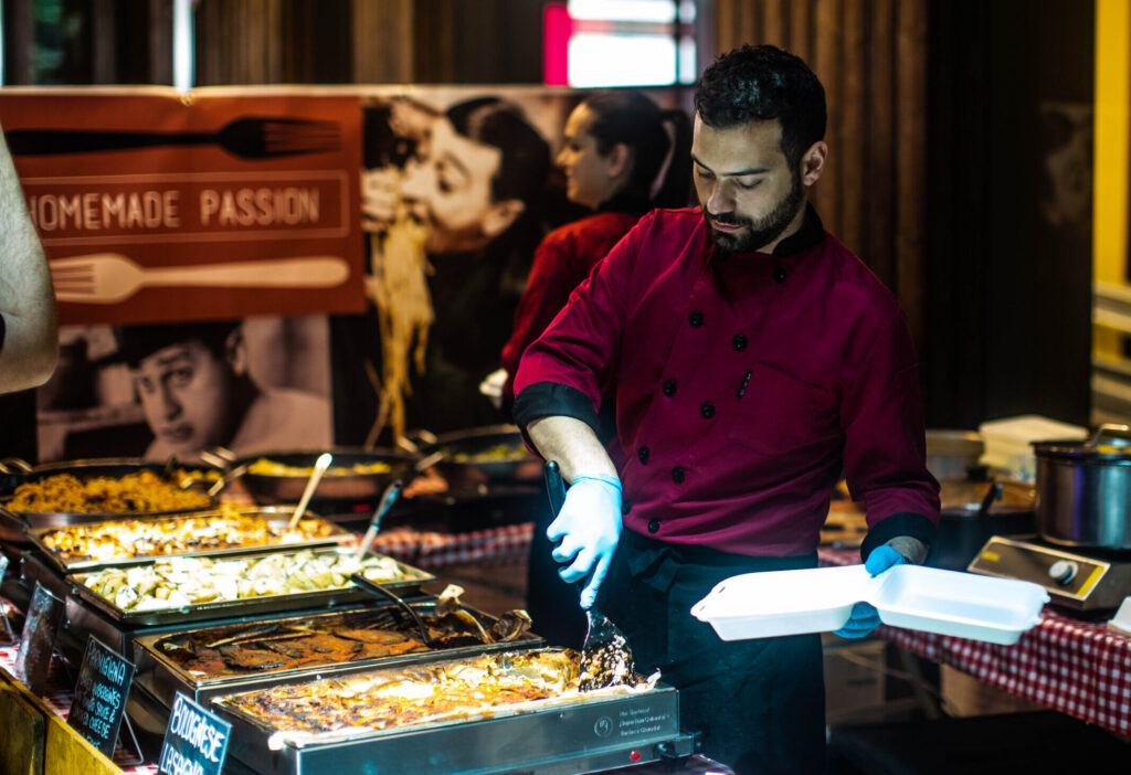 Trader serving pasta for a corporate lunch