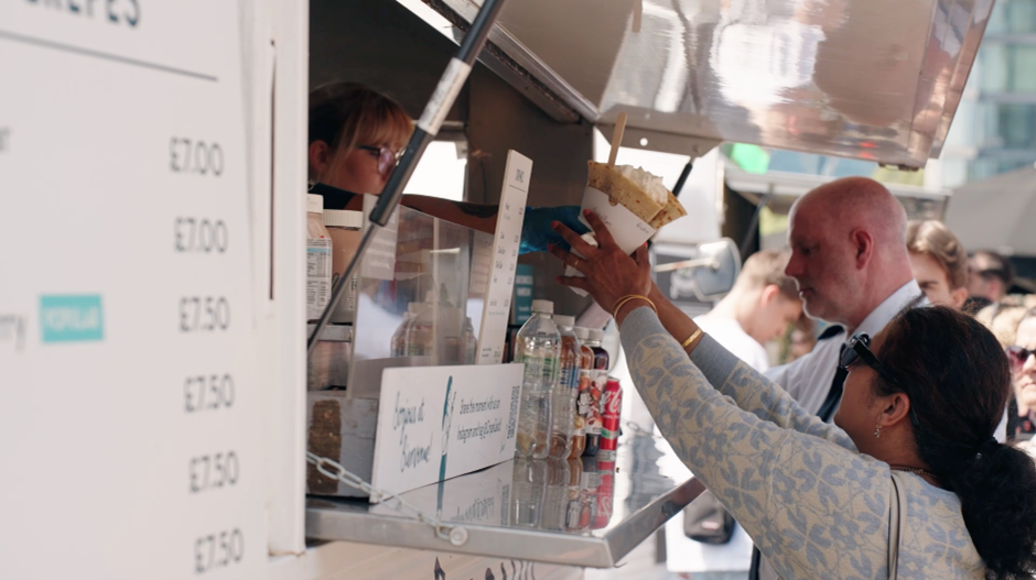 Weekend customers buying crepes from street food van