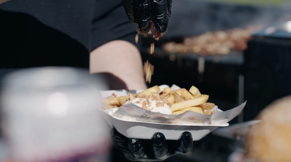 Customer being served chips and toppings